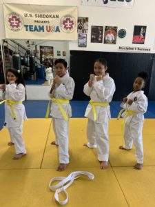 Four students after earning their yellow belt.